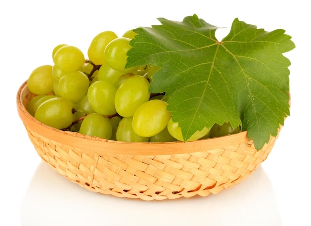 Ripe delicious grapes in wicker basket isolated on white