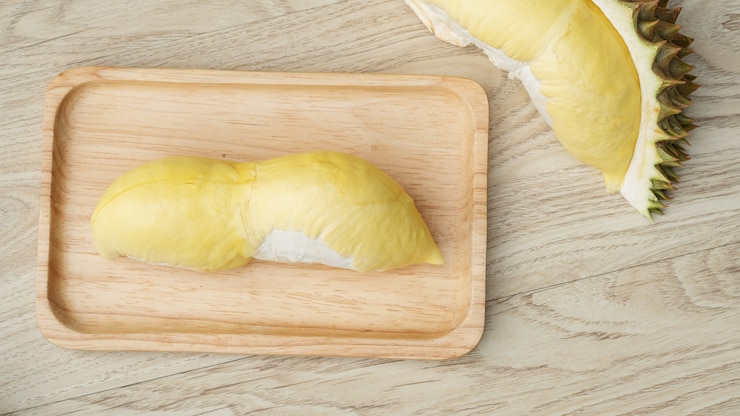 Photo ripe durian fruit on a wooden table.