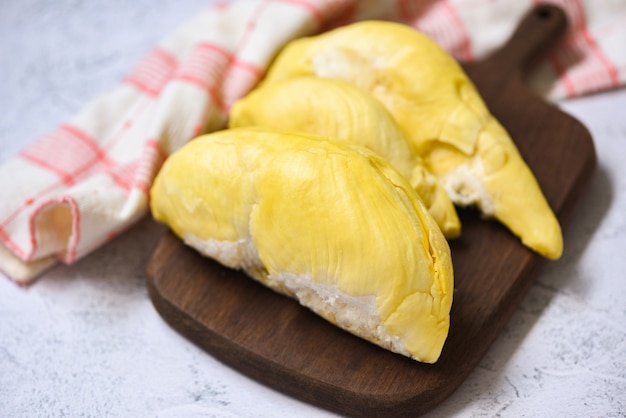 Ripe durian tropical fruit on a wooden plate