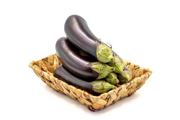 Ripe eggplant Fresh eggplants in basket isolated on white background Organic food close up