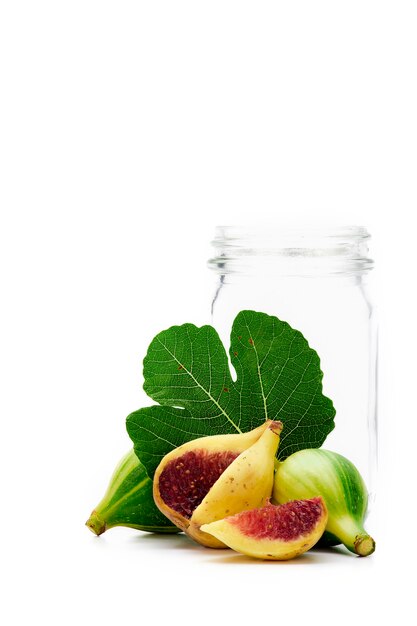 Ripe figs and Empty glass bottle on white