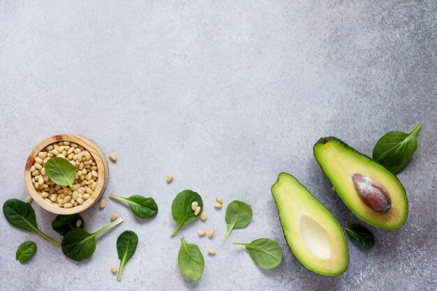 Ripe fresh avocado and spinach leaves