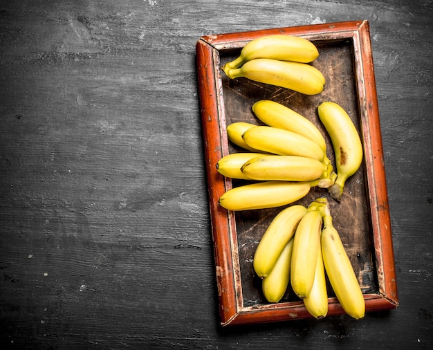 Ripe fresh bananas. On a black chalkboard.