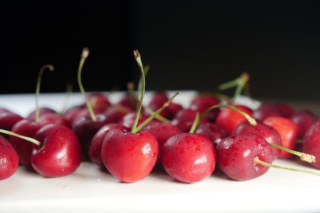 Ripe fresh cherry on a white tray