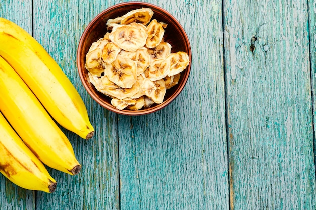 Ripe fresh and dried banana.Dried sweet on wooden background.Copy space