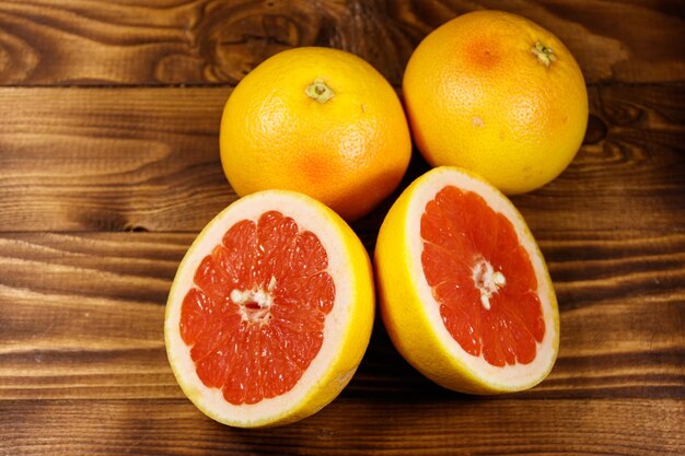Ripe fresh grapefruits on wooden table