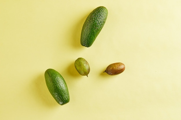 Ripe fresh mini avocados and mini lemons isolated