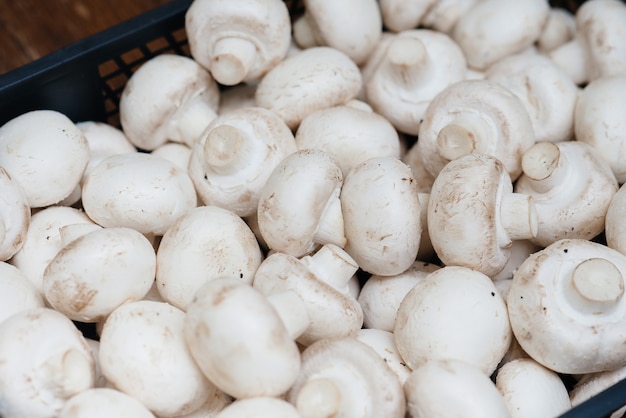 Ripe fresh mushrooms in a box in the warehouse after assembling a close-up