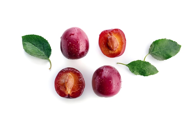 Ripe fresh plums on white background