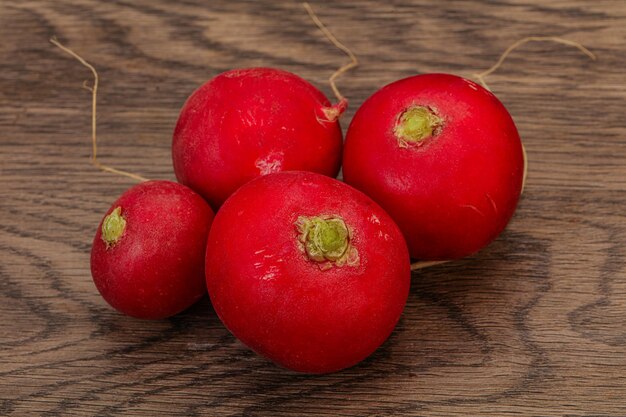 Ripe fresh radish heap over wooden background