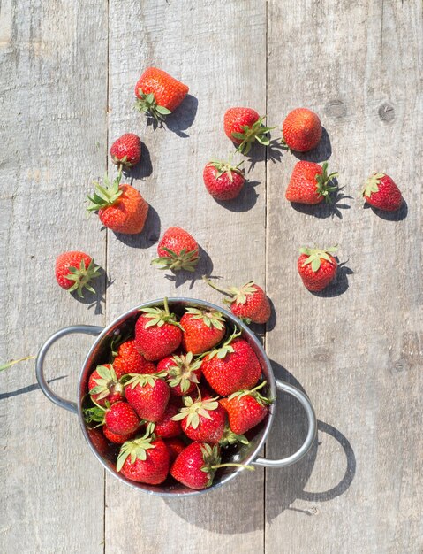 Ripe fresh strawberries in bowl freshly harvested fruits on farmer market top view copy space