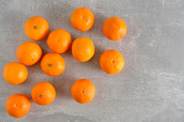 Ripe and fresh tangerines gray concrete background