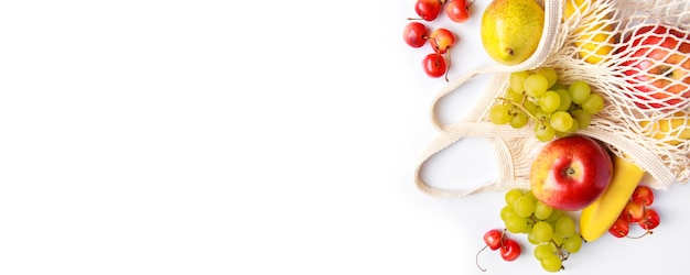 Ripe fruits in ecofriendly mesh bag on a white background Organic vegan food Trendy string bag