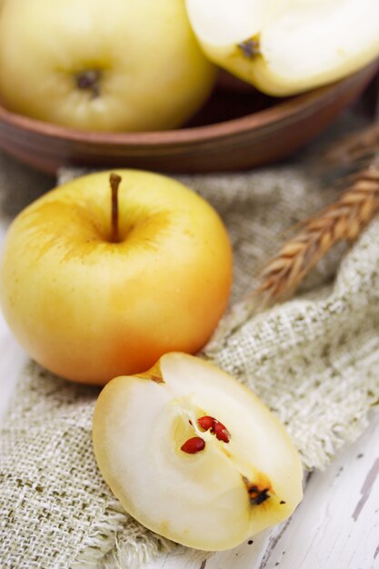 Ripe golden apples in a wooden bowl