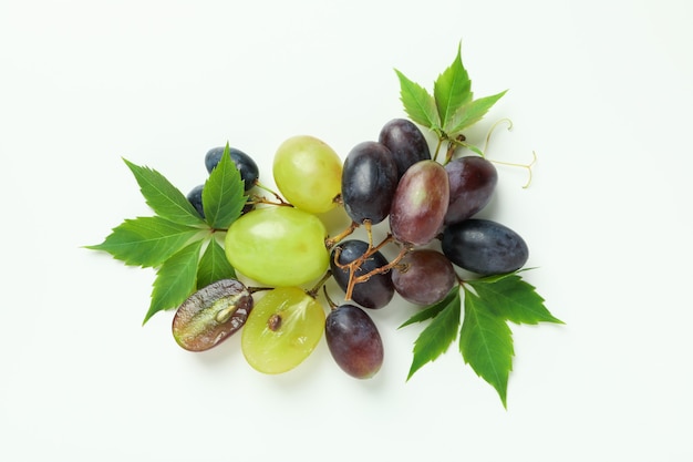 Ripe grape with leaves on white background