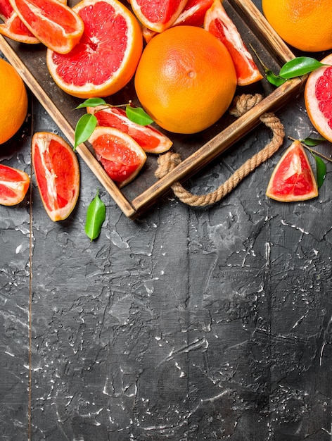 Ripe grapefruit on a wooden tray