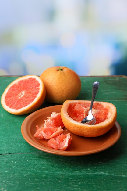 Ripe grapefruits on color wooden background