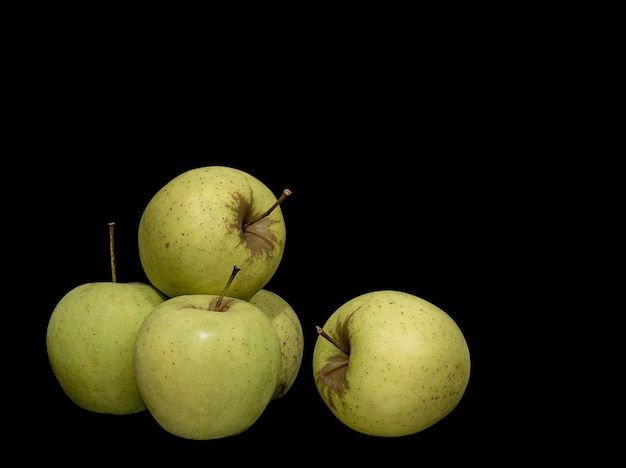 Ripe green apples on black background