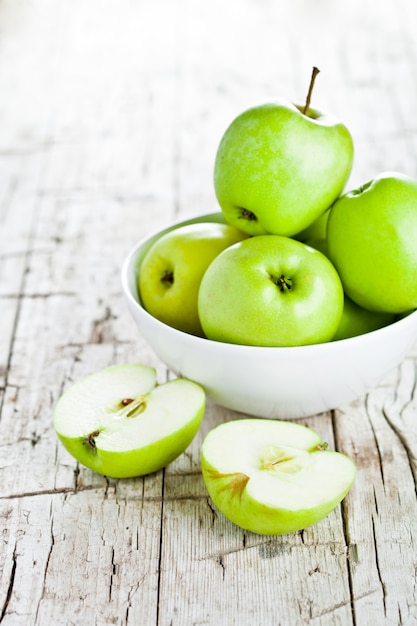 Ripe green apples in bowl 