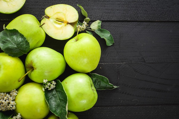 Ripe green apples on the green background