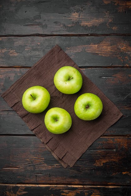 Ripe green apples set, on old dark rustic table background, top view flat lay