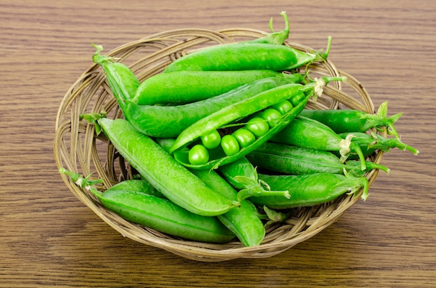 Ripe green pea pods in basket