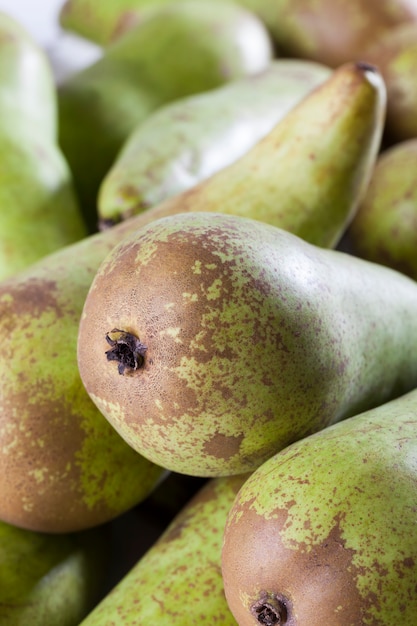 Ripe green pears after harvest, a bunch of delicious green pears on the kitchen table