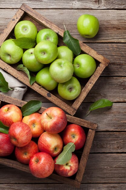 Ripe green and red apples in wooden box Top view