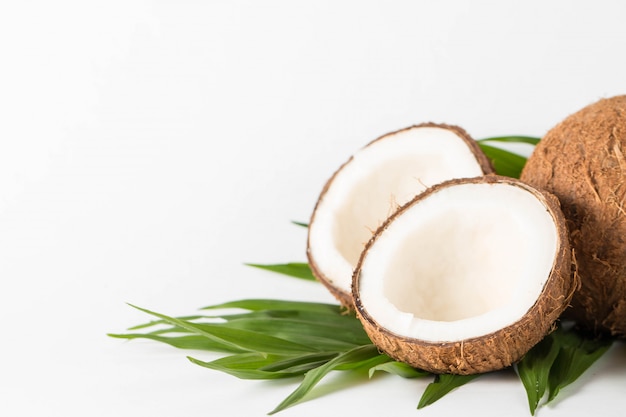 Ripe half cut coconut on a wooden background. Coconut cream and oil.