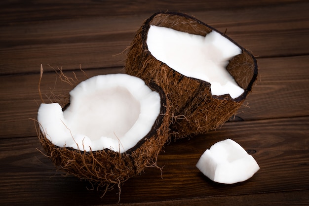 Ripe half cut coconut on a wooden background