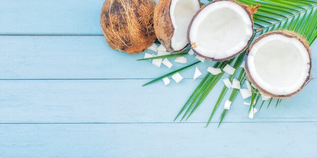 ripe half cut coconut on a wooden background.