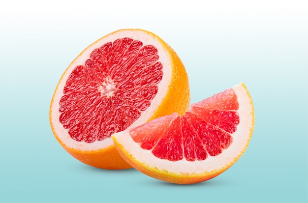 Ripe half of pink grapefruit citrus fruit isolated on bluebackground