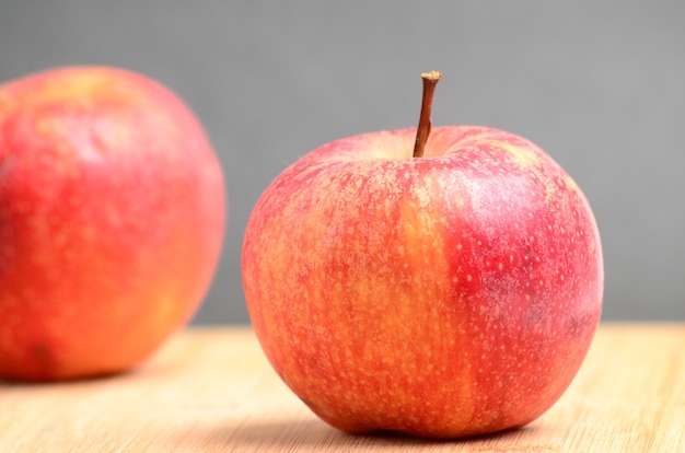 Ripe juicy apples on wooden background