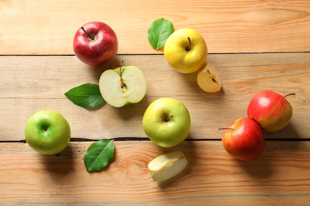 Ripe juicy apples on wooden table top view