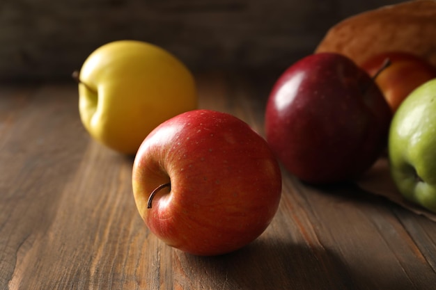 Ripe juicy apples on wooden table