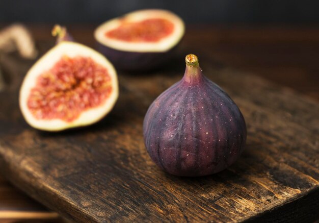 ripe juicy fig on wooden table