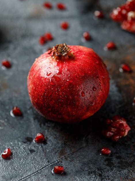 Ripe juicy pomegranate on grey background Food background