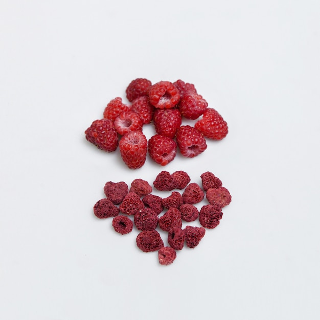 Ripe and juicy raspberries with dried fruits