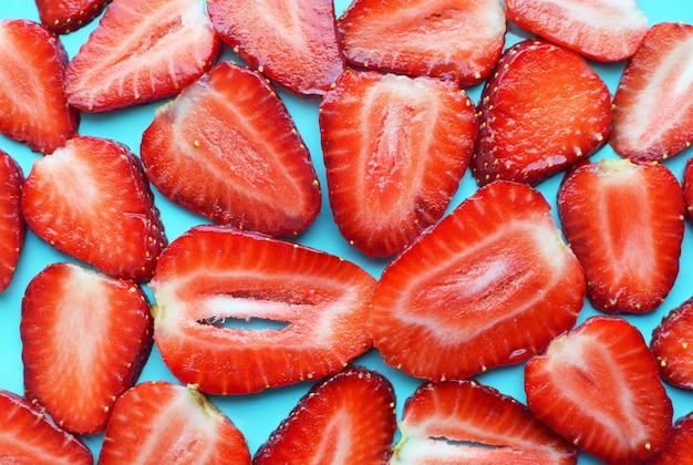 Ripe juicy strawberries cut into thin slices Background from strawberries Red berries