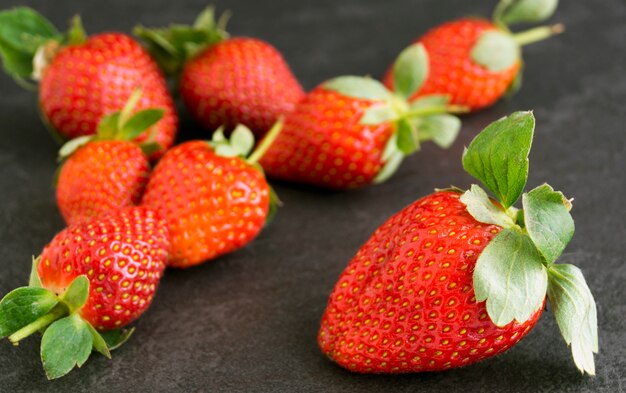 Ripe juicy strawberries on a gray background.