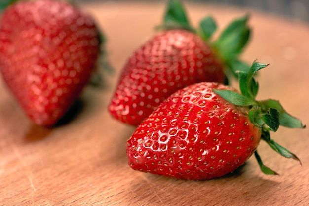 Ripe juicy strawberries on a wooden board