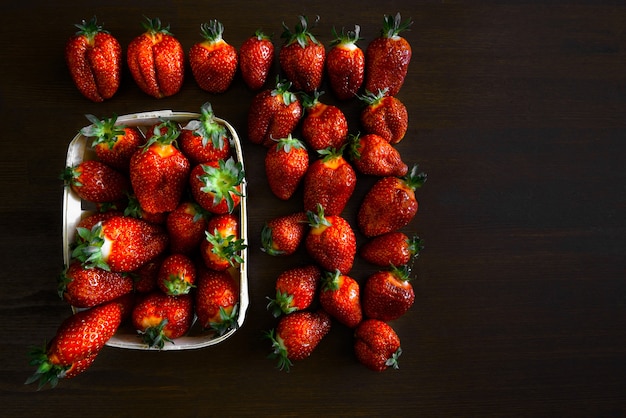 Ripe juicy strawberries on a wooden table in a basket