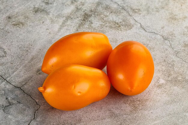 Ripe juicy yellow small tomato heap