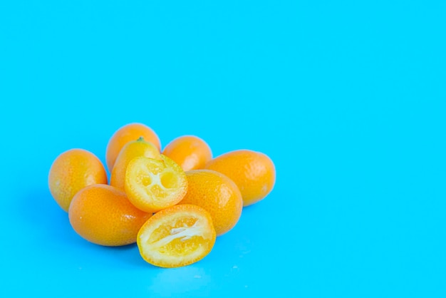 Ripe kumquat on a blue background, exotic citrus fruits