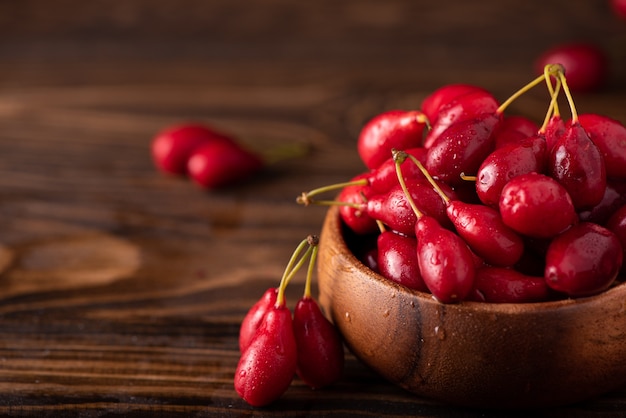 Ripe large dogwood berries in a wooden bowl