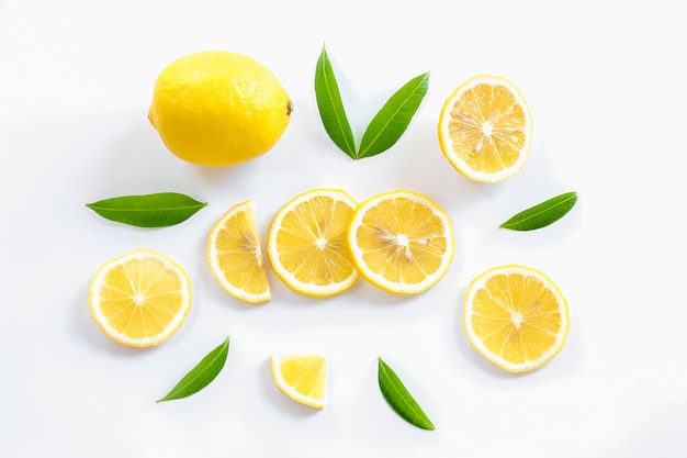 Ripe lemon and slices with leaves 
