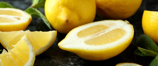 Ripe lemons on black smokey, close up