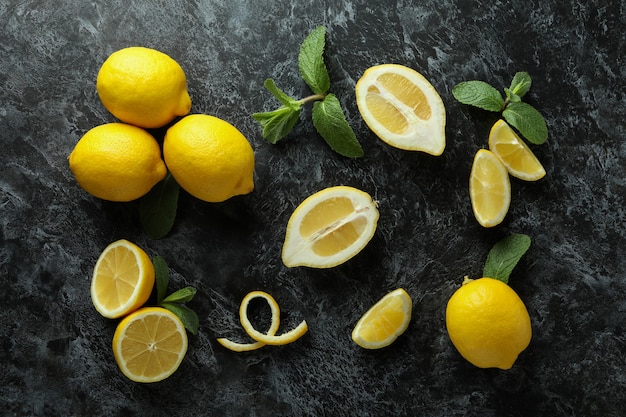 Ripe lemons on black smokey, top view