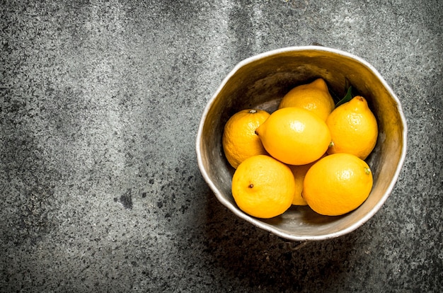 Ripe lemons in the old bucket