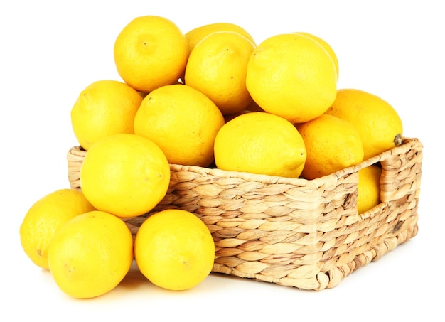 Ripe lemons in wicker basket isolated on white